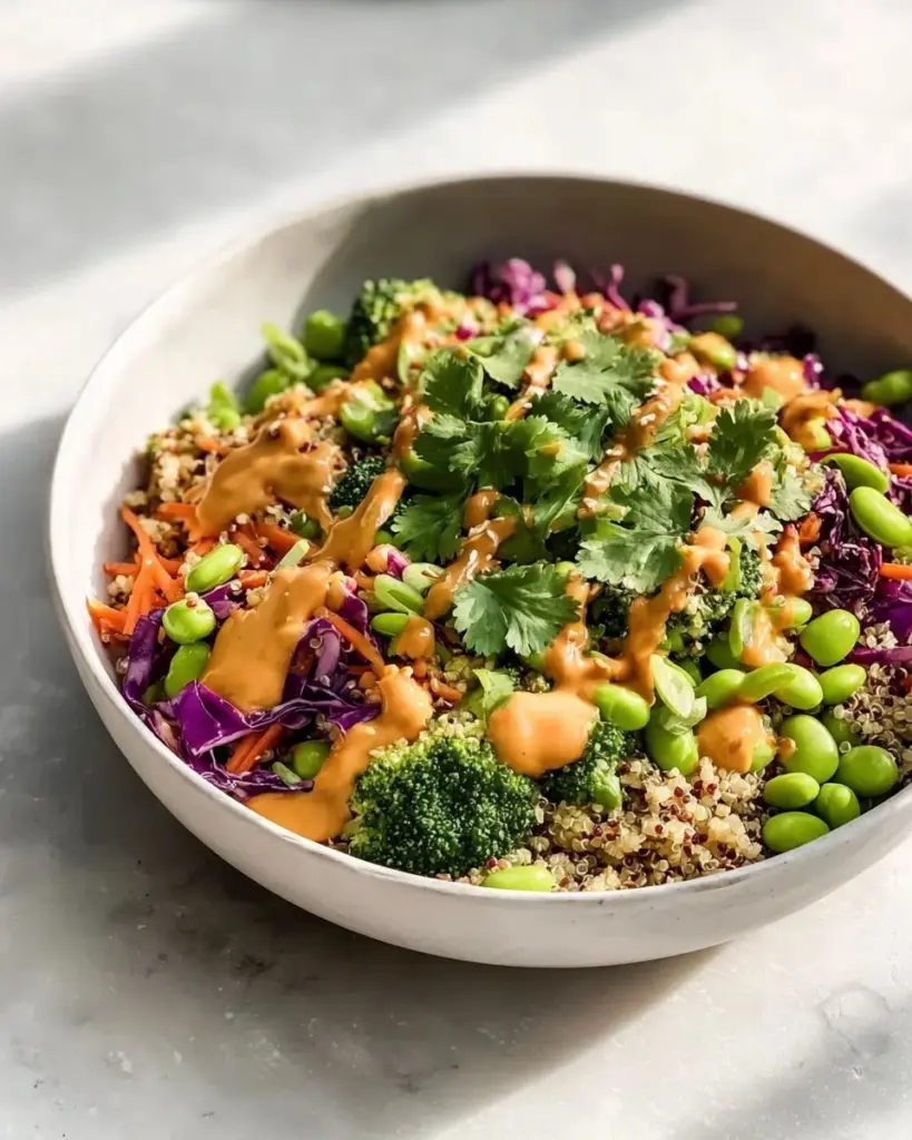 Bowl of crunchy Asian edamame salad with peanut dressing and colorful vegetables