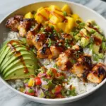 Grilled Maple Sriracha Chicken bites served with coconut rice and mango avocado salsa