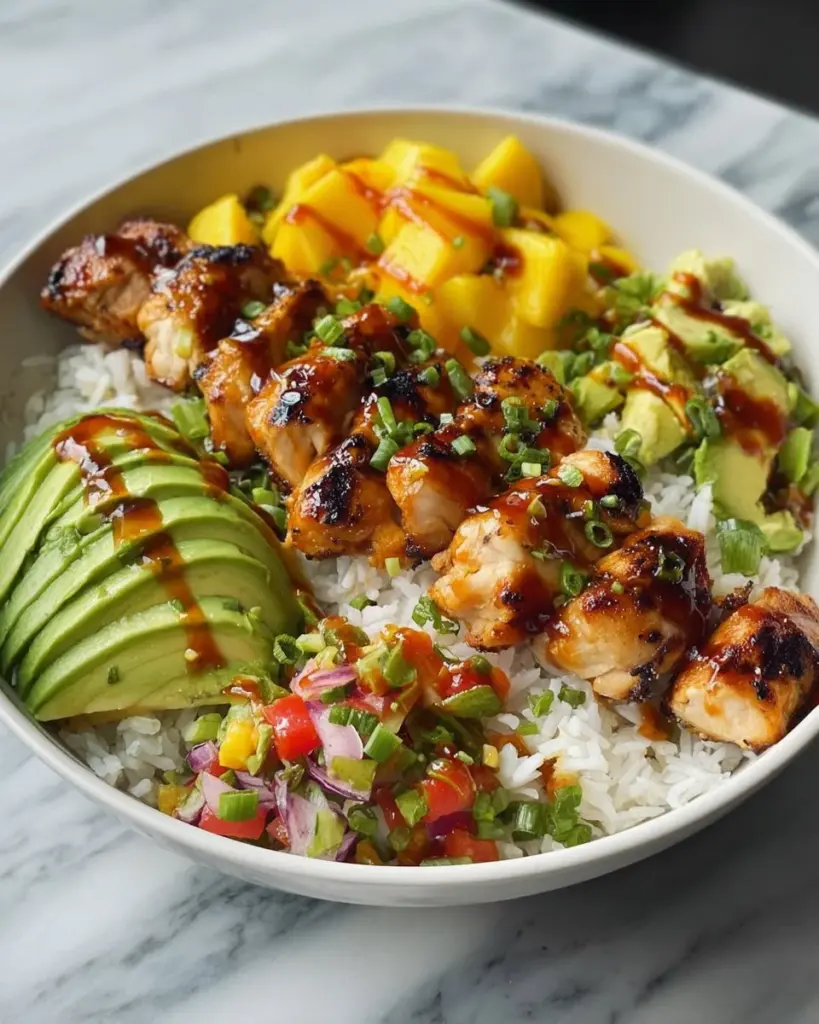 Grilled Maple Sriracha Chicken bites served with coconut rice and mango avocado salsa