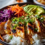 Plate of Spicy Maple Chicken served with coconut rice and garnished with herbs.