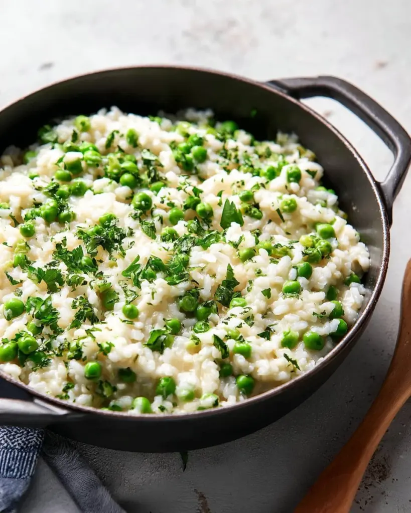 A vibrant plate of rice and peas garnished with herbs, showcasing a traditional dish.