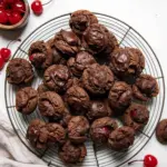 Plate of homemade Chocolate Covered Cherry Cookies with cherries and chocolate glaze.