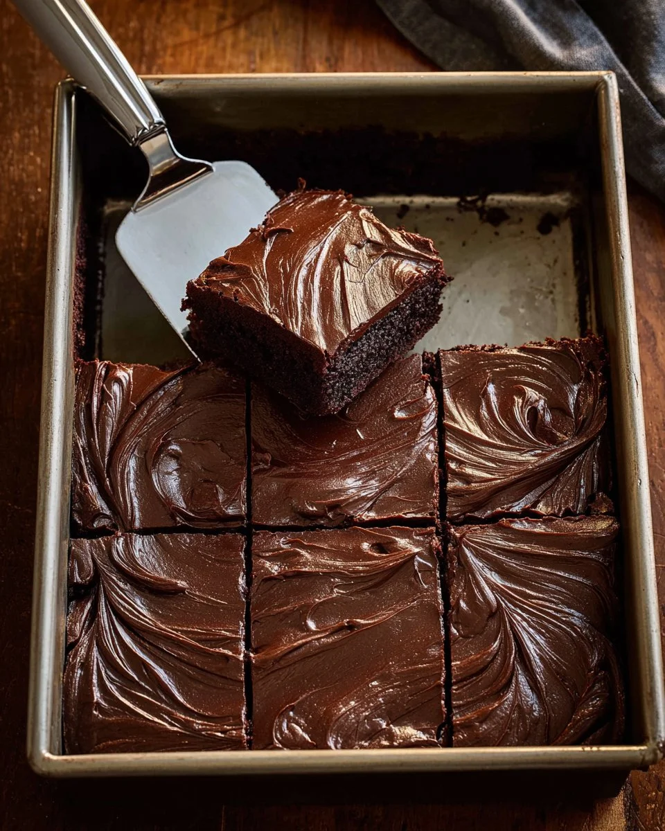Slice of Double Fudge Whiskey Cake with chocolate and whiskey drizzle