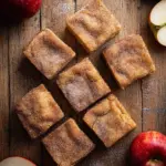 Freshly baked apple cider blondies topped with a drizzle of caramel