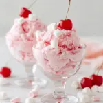Delicious Cherry Cheesecake Fluff dessert in a bowl topped with cherries