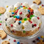 Delicious Monster Cookie Cheesecake topped with cookies and colorful sprinkles.