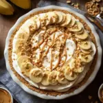 Peanut Butter Banana Cream Pie topped with whipped cream and banana slices.